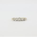 An antique 18ct yellow gold and platinum (worn stamp 18ct) ring set with five graduated old cut