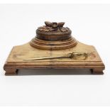 A carved oak desk stand, made from the wood of HMS Daedalus, W. 27cm, together with a brass naval