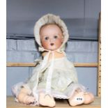 A large Armand Marseilles porcelain head and composition bodied baby doll, H. 52cm.