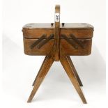 A 1950's oak workbox and contents, H. 54cm.