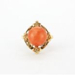 An early 20th century 9ct yellow gold ring set with cabochon cut coral, (M).