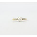 An 18ct gold and platinum solitaire ring set with a brilliant cut diamond, approx. 0.50ct, (M).
