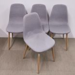 A set of four modern upholstered metal leg dining chairs.