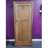 A carved light oak wardrobe with camphor interior, 180 x 38 x 72cm.