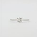 A 9ct white gold diamond set cluster ring, (T.5).