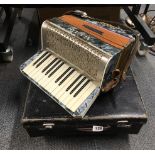 A cased Alvari piano accordian.