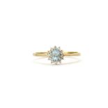 A 9ct yellow gold aquamarine and diamond set cluster ring, (R.5).