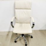 An adjustable metal office chair in cream.
