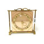 An Art Deco peach glass and gilt brass mantel clock with original electric movement, H. 19cm.