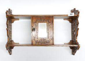 A lovely 1920's fretworked walnut hall shelf, H. 47cm, W. 54cm with lion details to sides.