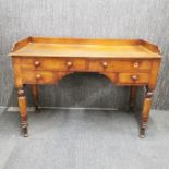 A four drawer ladies writing desk with turned wooden legs. One knob missing. 81 x 110 x 50cm.
