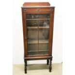 A 1920's oak display cabinet with barley twist legs, 140 x 57 x 30cm.