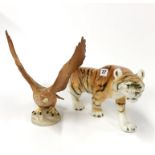 A large Royal Dux porcelain figurine of a tiger, L. 42cm, together with a Beswick golden eagle.