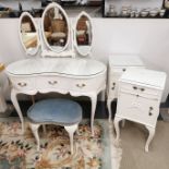 A painted white and glass topped, mirror backed kidney dressing table and stool with two matching
