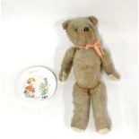 A straw filled articulated teddy bear, H. 49cm, together with a Shelley children's plate.