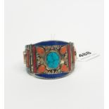 A Tibetan white metal stone set Kampa Tribe hinged bangle. W. 5.5cm, internal Dia. 6.2cm.