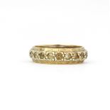 A hallmarked 9ct yellow gold stone set eternity ring, (O.5).