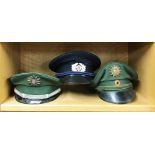 Three vintage police caps for Germany and Eastern German Transport Police.