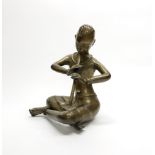 An early 20thC Himalayan bronze figure of a monk playing a flute, H. 31cm.