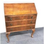 A three drawer walnut and mahogany bureau, 95 x 73cm.