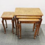 A burr walnut veneered nest of three tables together with a burr walnut veneered side table, largest