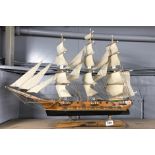 A wooden model of a sailing ship, H. 52cm, L. 72cm.