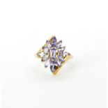 A 9ct yellow gold ring set with marquise cut tanzanites, (O).