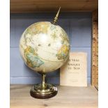 A vintage globe, H. 53cm, together with a copy of In French, a volume about South Africa, c. 1981.