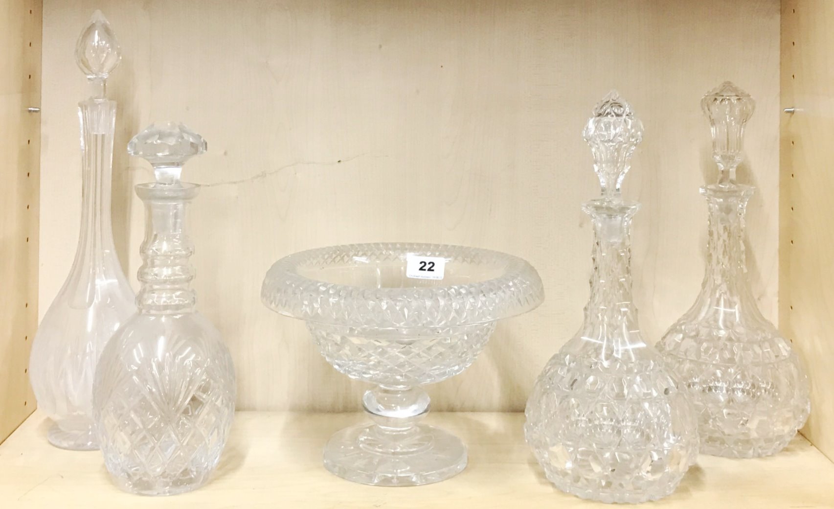 A 19th century cut crystal fruit bowl with four cut glass decanters, one decanter A/F to rim.