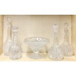 A 19th century cut crystal fruit bowl with four cut glass decanters, one decanter A/F to rim.