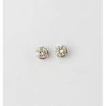 A pair of white metal (tested 18ct gold) stud earrings set with brilliant cut diamonds, approx. 0.
