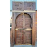 A pair of large Oriental carved pine doors with arched side frames, door H. 200cm.