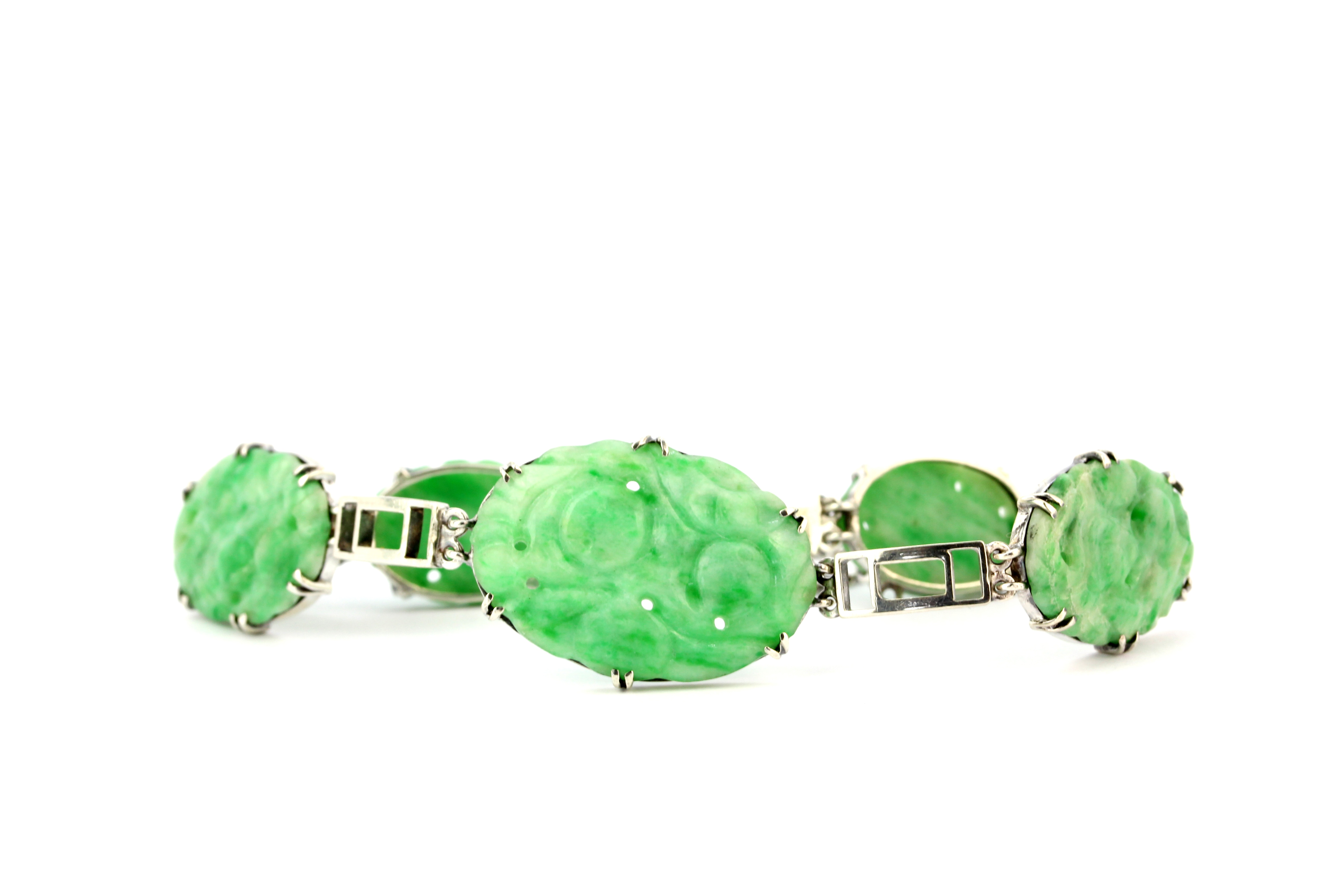 A white metal (tested high carat gold) bracelet set with carved jade, L. 23cm. - Image 3 of 4