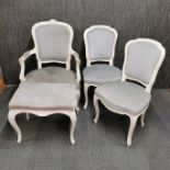 A pair of white painted and upholstered chairs together with a matching armchair and footstool.