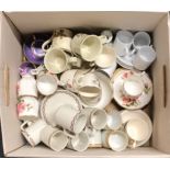 A large quantity of mixed coffee cups and saucers.