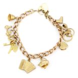 A heavy hallmarked 9ct yellow gold charm bracelet and 9ct gold charms, L. 13cm.