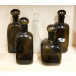 Four 1970's smoked glass bottles, tallest H. 28cm, together with a decanter.