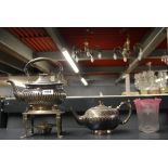 A silver plated spirit kettle and teapot with a Edwardian lamp shade.