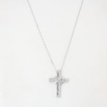 A large white metal (tested 18ct gold) cross pendant set with brilliant cut and baguette cut