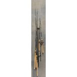 A group of fishing rods with an extensive quantity of fishing gear.