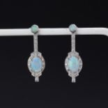 A pair of Art Deco style 18ct white gold drop earrings set with cabochon cut opals and brilliant cut