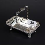 A Chester hallmarked silver pierced basket, W. 13cm. with a small silver salt spoon.