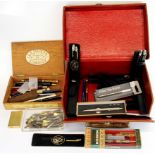 A collection of pens and other items in a gentleman's leather case.