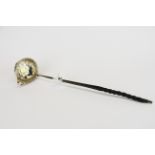 A 18thC silver and baleen toddy ladle inset with a 1762 quarter Guinea.
