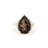 A hallmarked 9ct yellow gold ring set with a large pear cut smokey quartz and diamonds, (M).