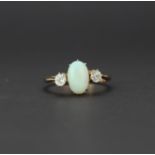 A yellow metal (tested minimum 9ct gold) ring set with a cabochon cut opal and white sapphires, (