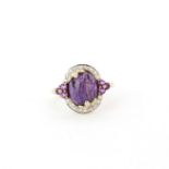 A 9ct yellow gold ring set with a cabochon cut charoite, amethysts and diamonds, (O.5).