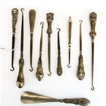 A group of nine silver handled button hooks, longest 22cm. together with a silver handled shoe