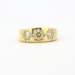 A large gent's 9ct yellow gold (stamped 9K) ring set with three brilliant cut diamonds, approx.