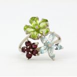 A 925 silver ring set with marquise cut aquamarine, oval cut peridots and tourmalines, (S.5).